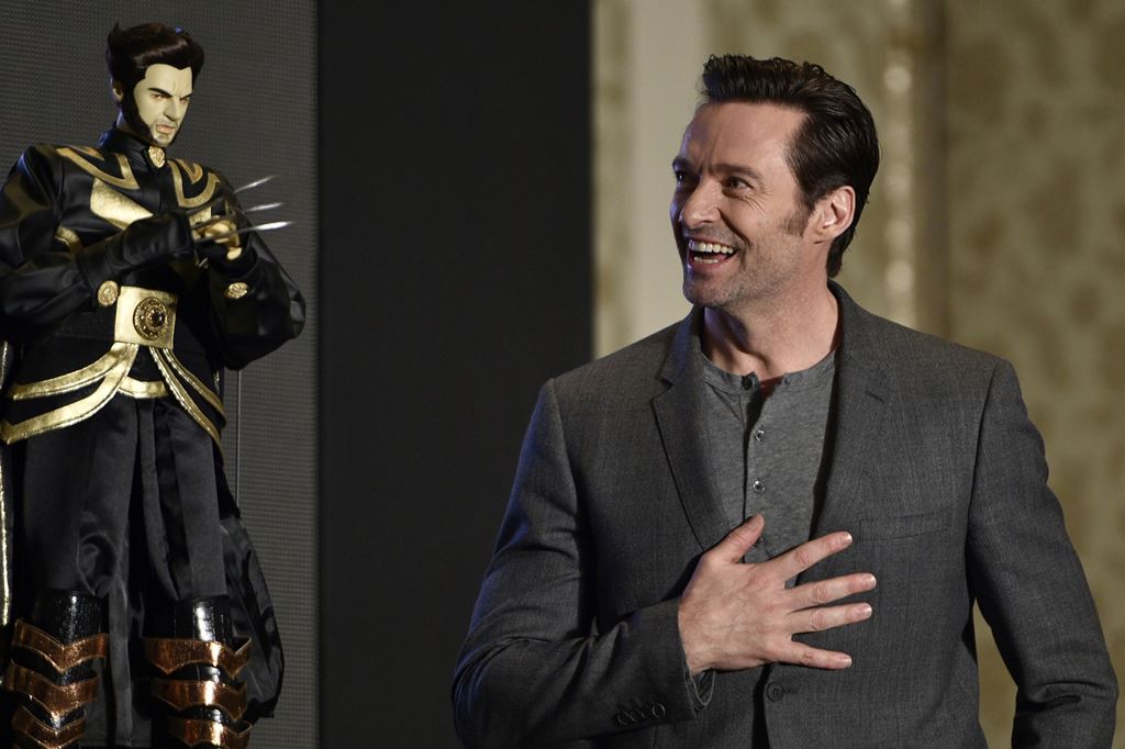 Australian actor Hugh Jackman admires a Wolverine puppet gift during a press conference for the film 