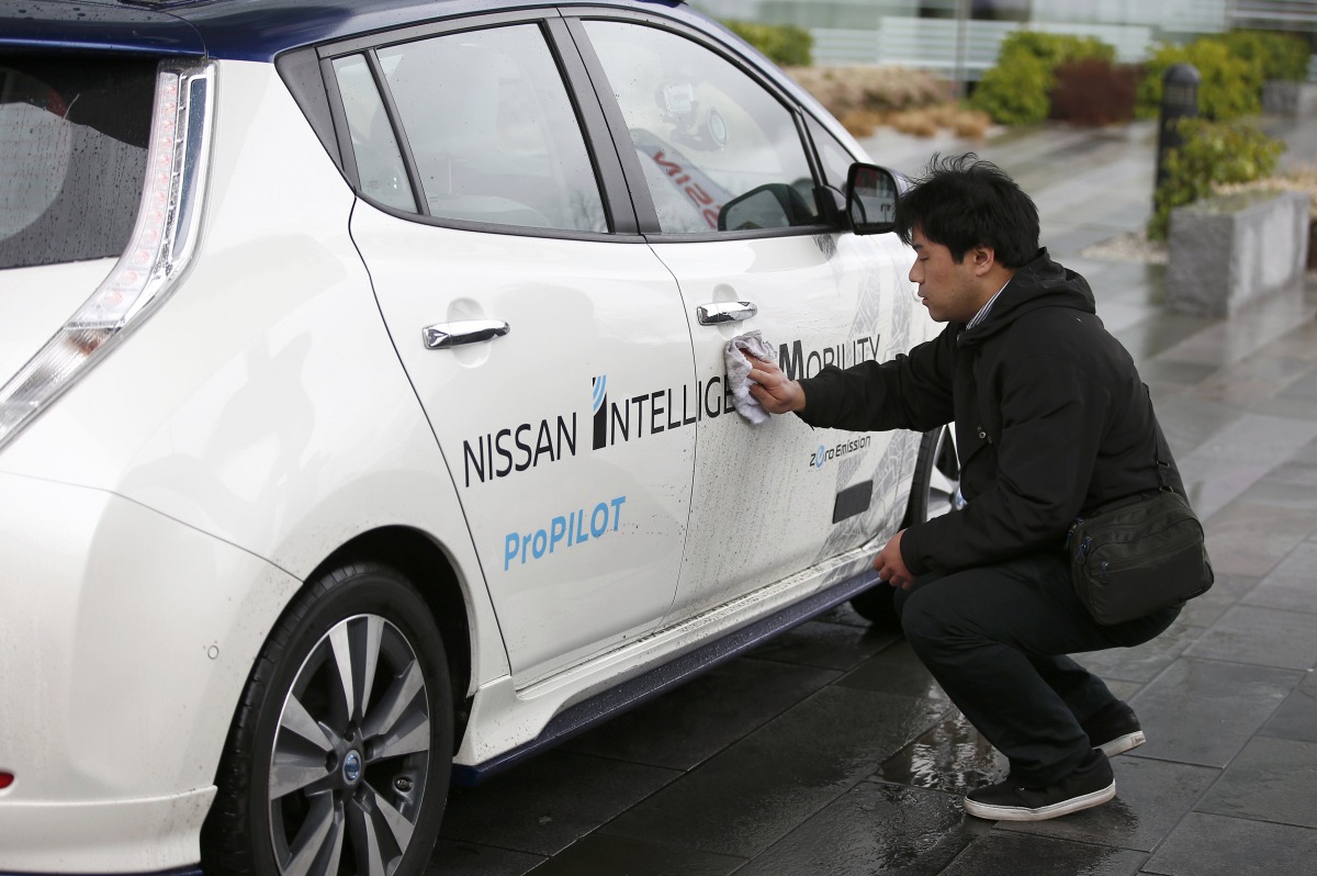 A technician cleans a modified Nissan Leaf, driverless car, between outings, during its first demonstration on public roads in Europe, in London, Britain February 27, 2017. REUTERS/Peter Nicholls