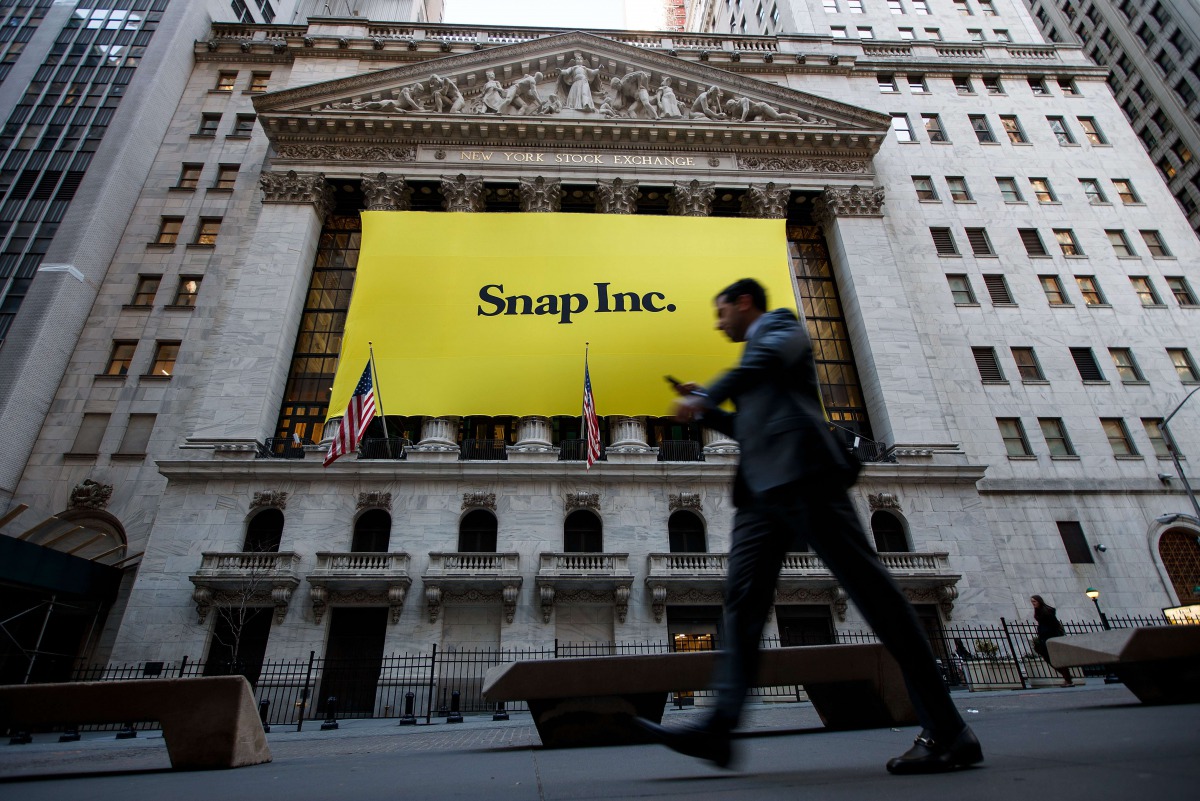 Signage for Snap Inc., parent company of Snapchat, adorns the front of the New York Stock Exchange (NYSE), March 2, 2017 in New York City. Snap Inc. priced its initial public offering at $17 a share on Wednesday and Snap shares will start trading on the N