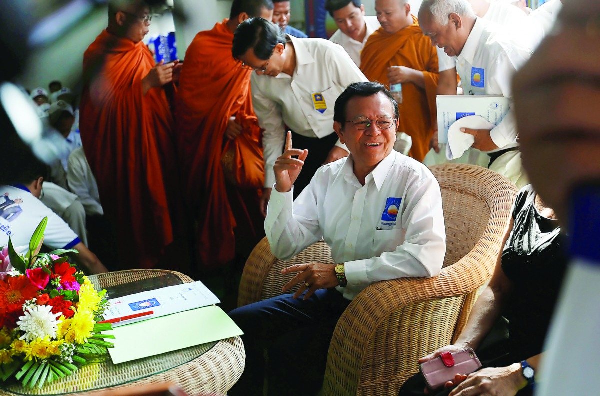 Kem Sokha, leader of the Cambodia National Rescue Party, gestures at party's headquarters in Phnom Penh, yesterday.