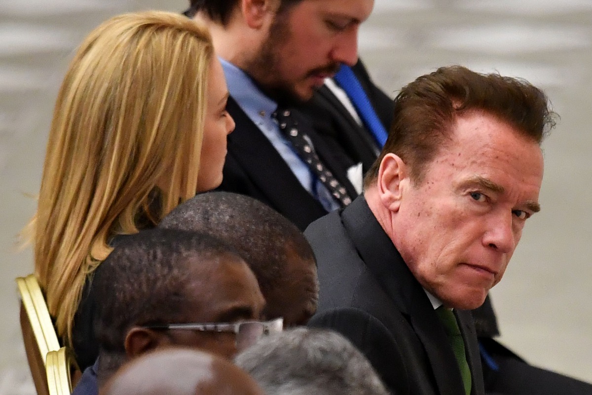 This file photo taken on January 25, 2017 shows US actor and former governor of California Arnold Schwarzenegger (R), flanked by his girlfriend Heather Milligan, as he attends the Pope's weekly general audience at the Paul VI hall of the Vatican. AFP / Al