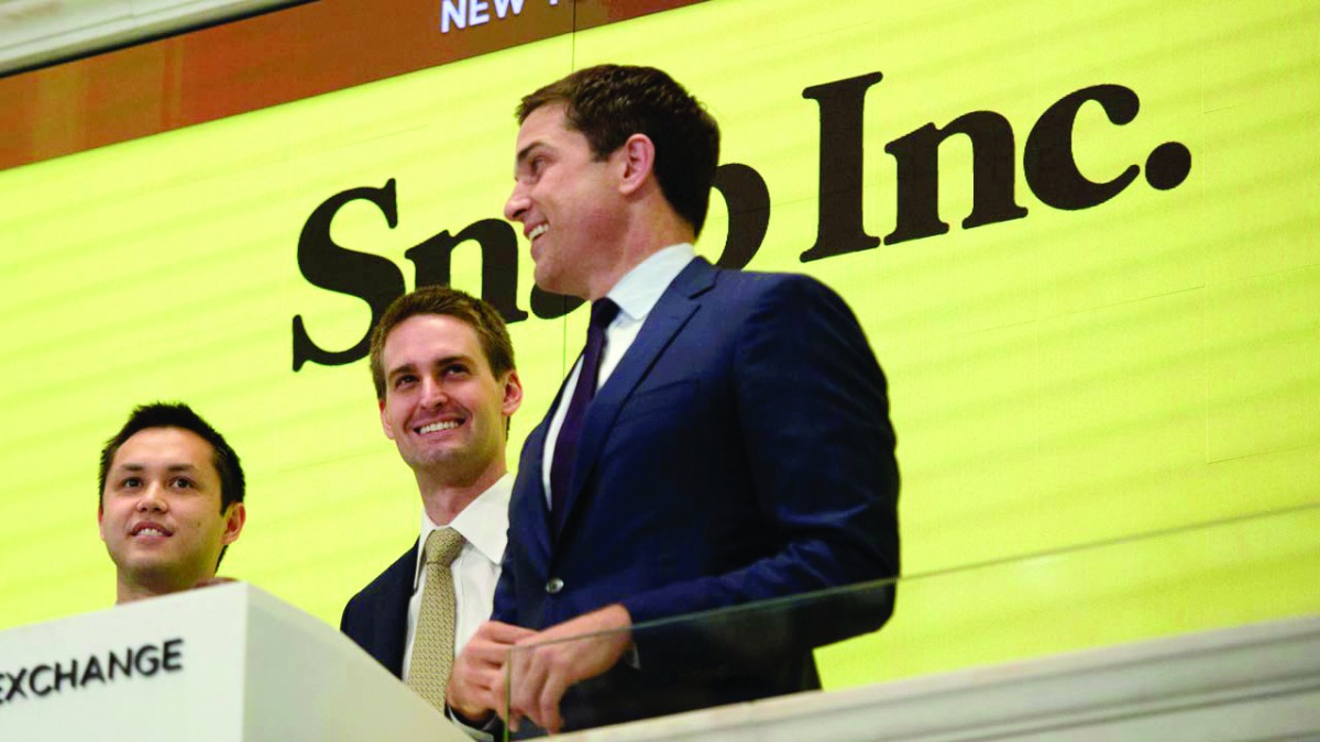 Snap Inc. co-founder Bobby Murphy(L) with CEO Evan Spiegel(C) and NYSE President Thomas Farley, ring the opening bell at the New York Stock Exchange on March 2, 2017 in New York. / AFP / Bryan R. Smith