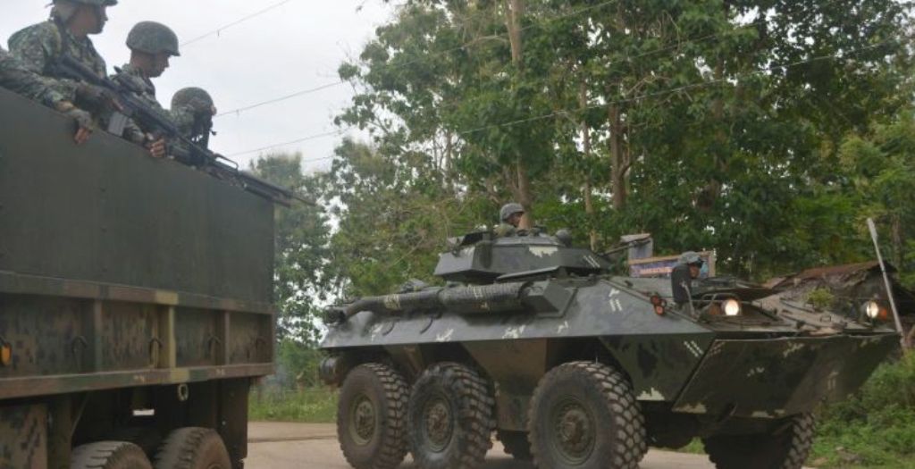 Philippine marines aboard an Amored Personnel Carrier and a truck guard a highway in Indanan town on the southern island of Mindanao on Feb 27, 2017, after reports of the beheading of German national Jurgen Kantner by the Abu Sayyaf group. (Photo: AFP/Nic
