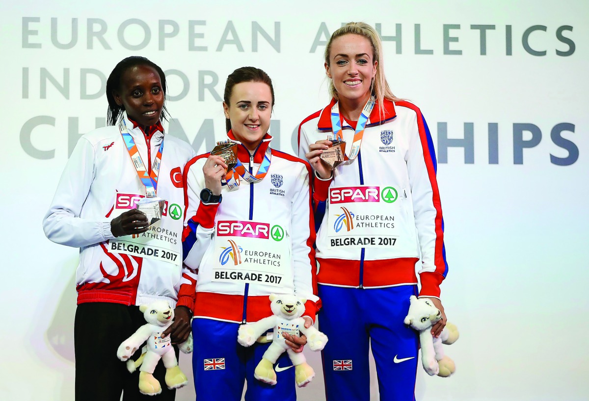 Winner Laura Muir (centre) and Eilish Mccolgan (third) of Britain and Yasemin Can of Turkey pose during the medals ceremony of women's 3000m at European Athletics Indoor Championship in Belgrade, Serbia on Sunday. 