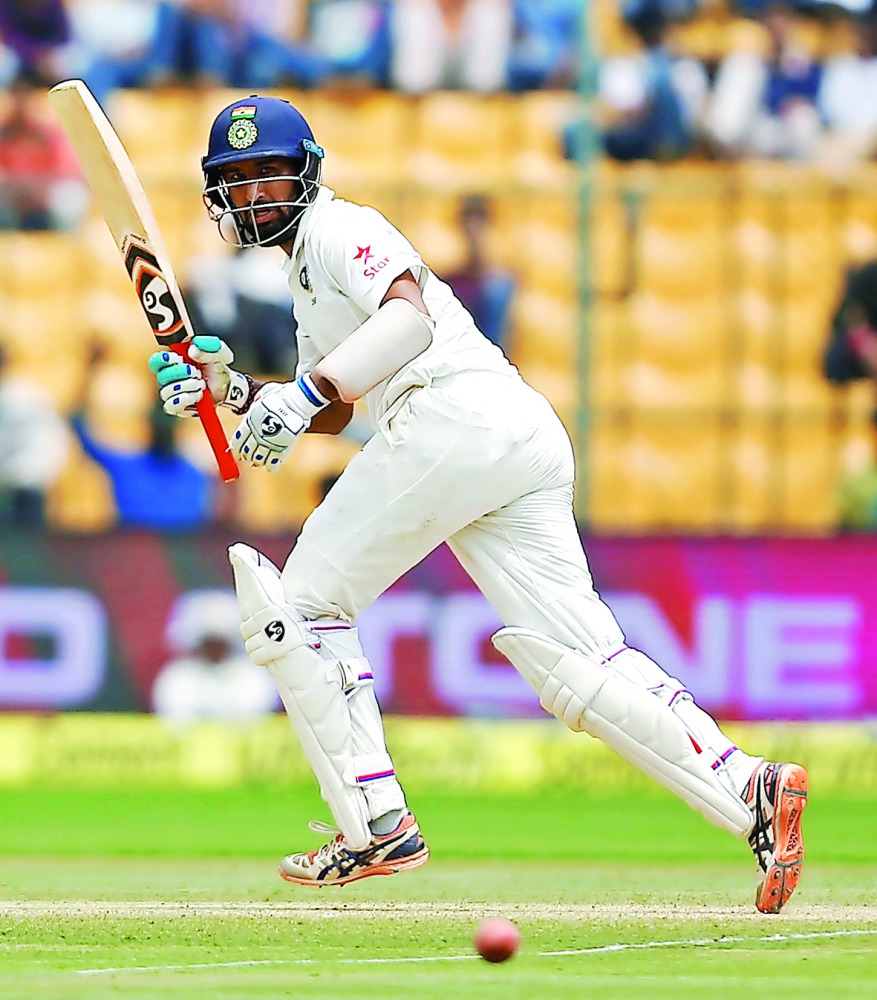 India's Cheteshwar Pujara plays a shot on third day of second Test against Australia at M Chinnaswamy Stadium in Bangalore India yesterday. 