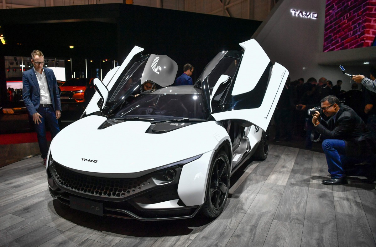 People look at a Tamo Racemo Sports Coupe by Indian carmaker Tata motors' sub-brand Tamo at the Indian carmaker stand during the first press day of the Geneva International Motor Show on March 7, 2017 in Geneva. Europe's biggest annual car show kicks off 