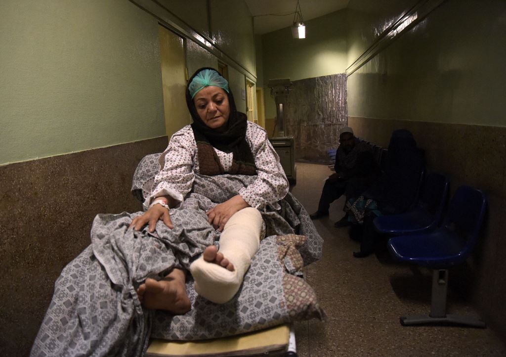A wounded Afghan nurse waits to be X-rayed at a hospital in Kabul on March 9, 2017, after she was injured during an attack on the main military hospital in the Afghan capital. AFP / Shah Marai 