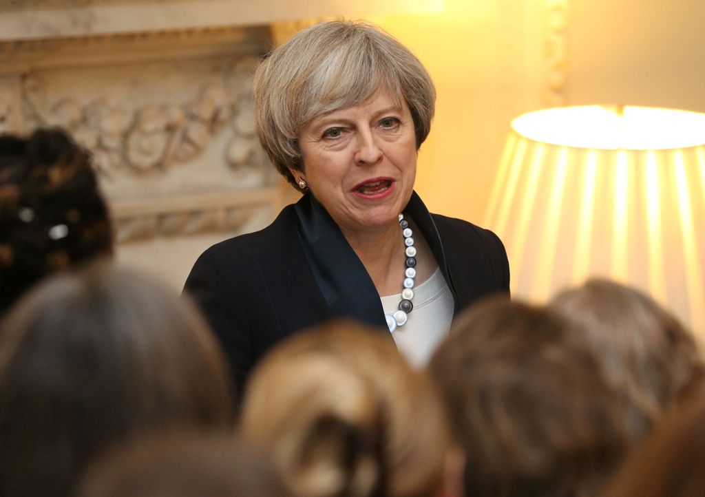 British Prime Minister Theresa May speaks to guests during an International Women's Day reception at 10 Downing Street in London on March 8, 2017. / AFP / POOL / Jonathan Brady
