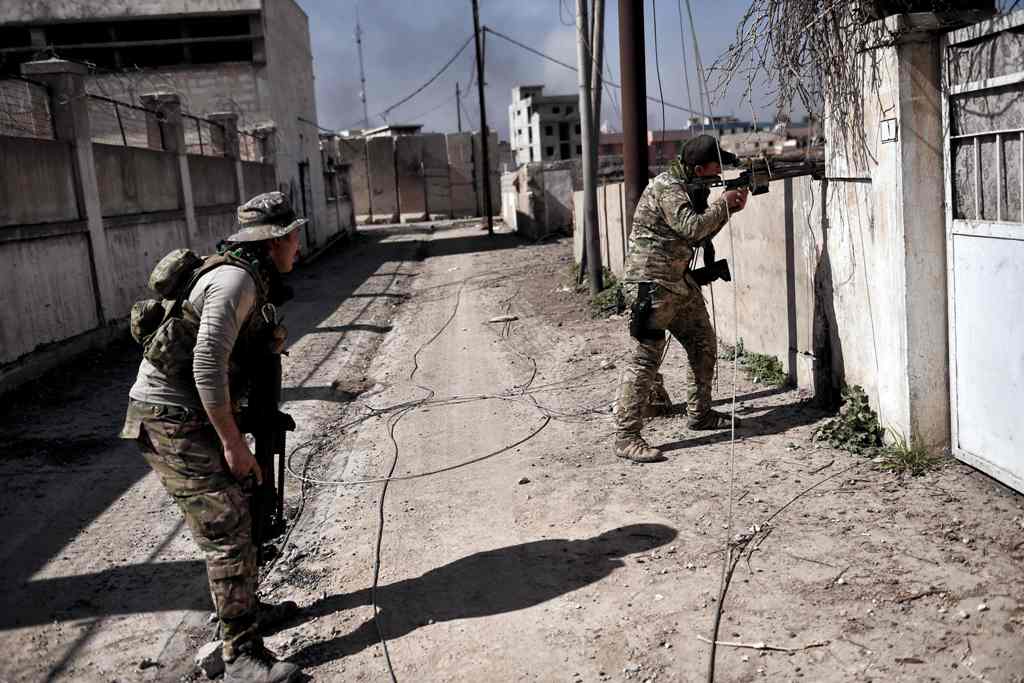 Members of the Iraqi forces patrol areas that they retook from Islamic State (IS) group fighters in western Mosul as they advance in the city in the ongoing battle to seize it from the jihadists on March 9, 2017.  AFP / ARIS MESSINIS
