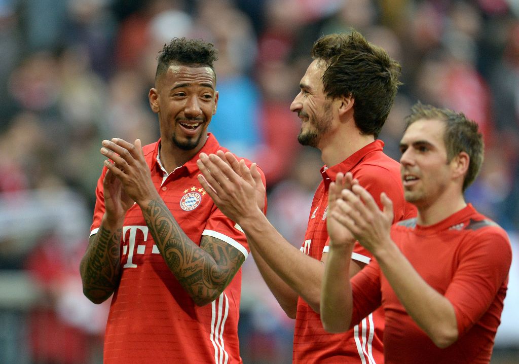 (L to R) Bayern Munich's defender Jerome Boateng, Bayern Munich's defender Mats Hummels and Bayern Munich's defender Philipp Lahm applaud after the German First division Bundesliga football match Bayern Munich vs Eintracht Frankfurt in Munich, southern Ge