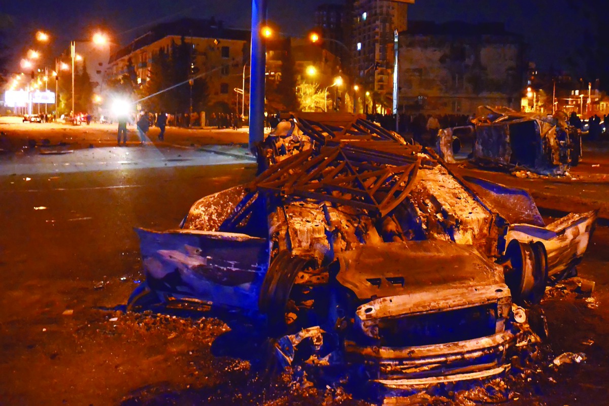 Burned cars seen on a street in Georgia's Black Sea port of Batumi during clashes between police and stone-throwing rioters following a protest by local residents against police officers arresting several men who refused to accept a parking fine. Nearly t