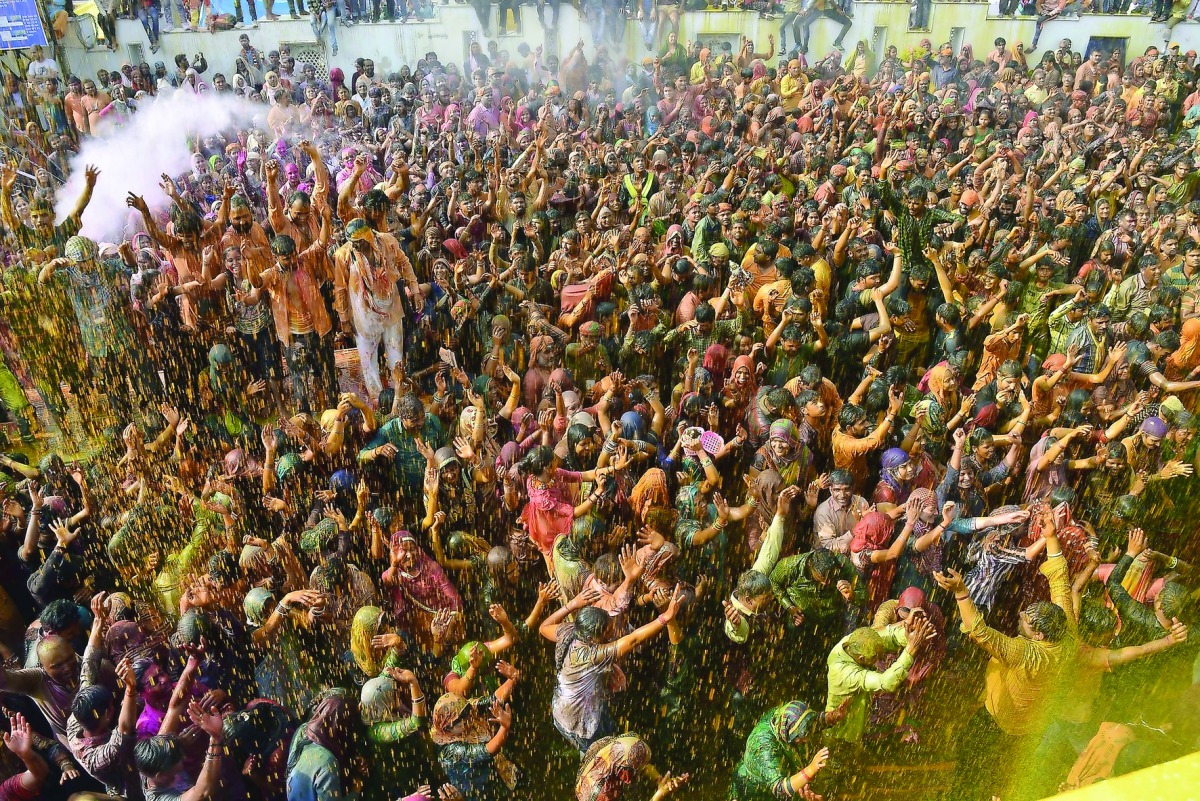 People celebrating Holi in Mathura, Uttar Pradesh, yesterday. Holi is observed in India at the end of the winter season on the last full moon of the lunar month. 