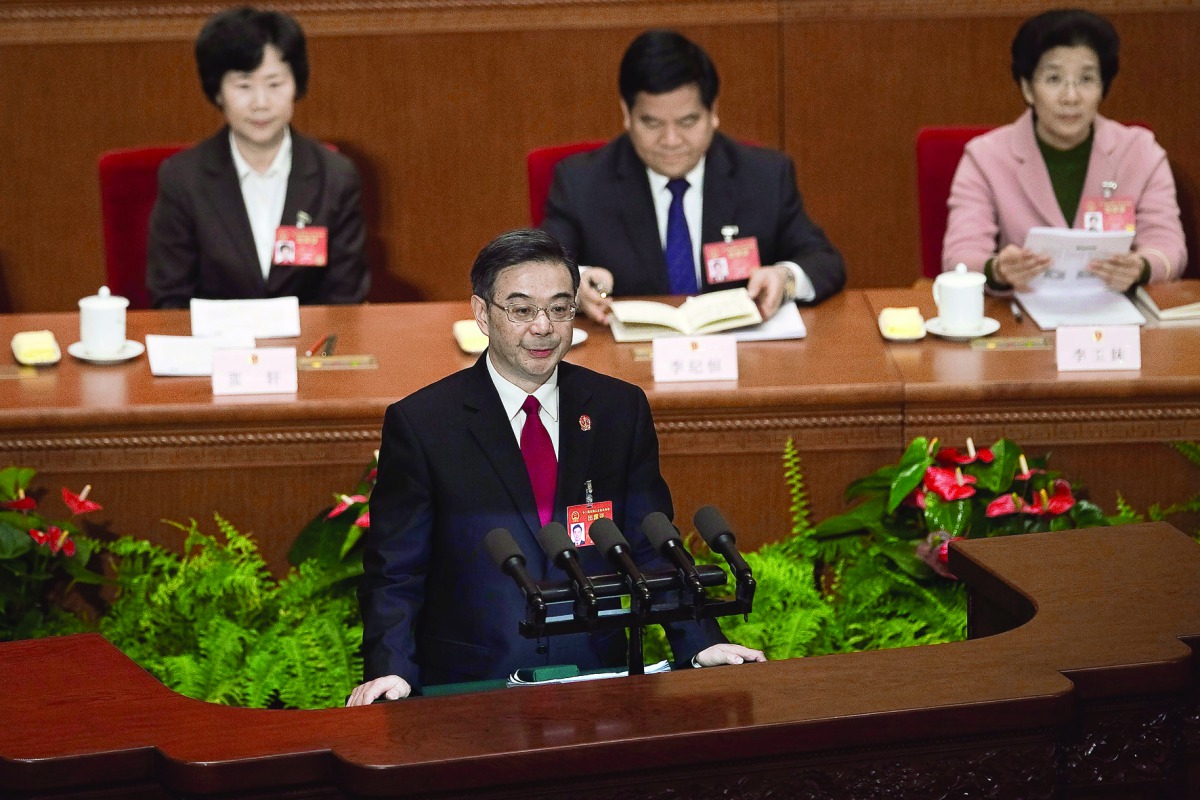 Zhou Qiang, President of the Supreme People's Court, speaking at the Third Plenary Session of the Fifth Session of the 12th National People's Congress at the Great Hall of the People in Beijing