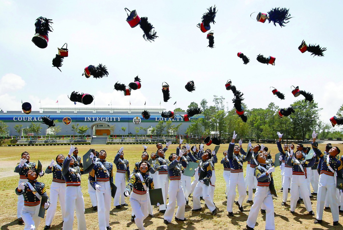 New officers of the Armed Forces of the Philippines throw their hats during graduation ceremonies at the Philippine Military Academy in Baguio city, in northern Philippines March 12, 2017. REUTERS/Harley Palangchao