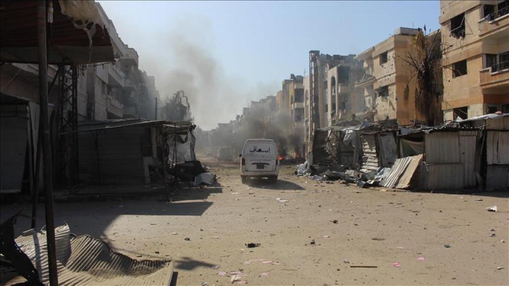 Damaged buildings are seen after war crafts belonging to Syrian army carried out airstrikes over residential areas despite cessation-of-hostilities agreement in Homs, Syria on March 8, 2017. ( Wasim Saduldin - Anadolu Agency ).