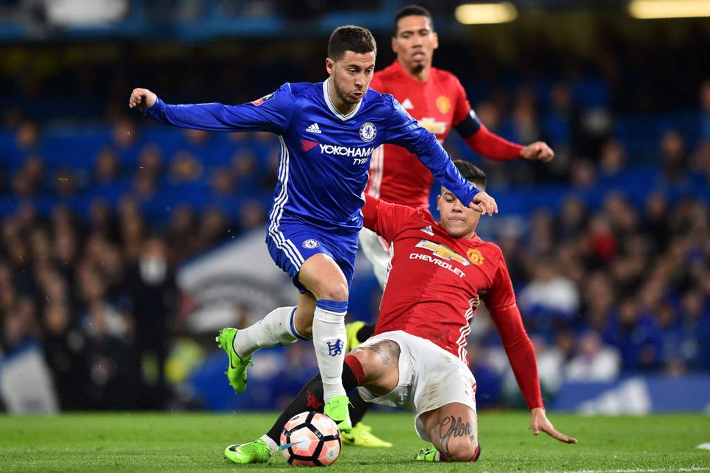 Chelsea's Belgian midfielder Eden Hazard (L) vies with Manchester United's Argentinian defender Marcos Rojo during the English FA Cup quarter final football match between Chelsea and Manchester United at Stamford Bridge in London on March 13, 2017.   AFP 