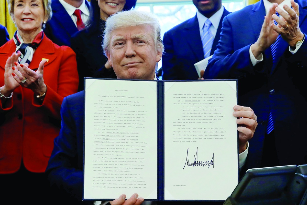 US President Donald Trump is applauded by his cabinet, including Small Business Administration (SBA) Administrator Linda McMahon (left), as he signs an executive order entitled 