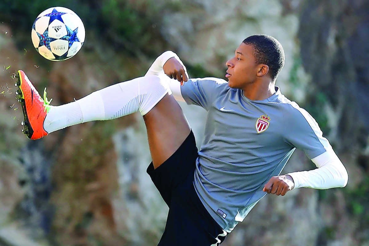Monaco striker Kylian Mbappe Lottin controls the ball during a training session on the eve of their UEFA Champions League match against Manchester City at the Louis II Stadium in Monaco. 