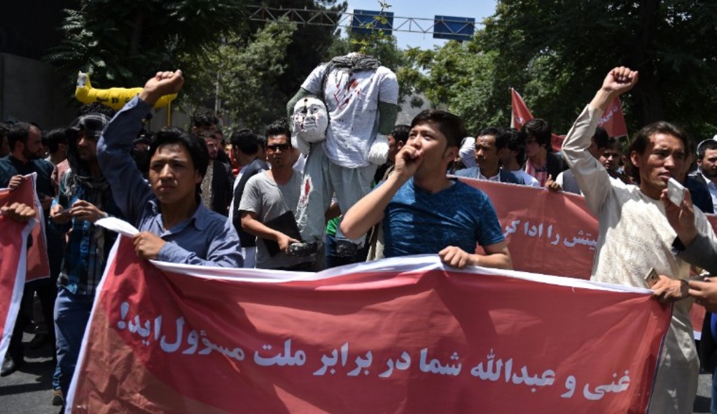Protesters chant anti-government slogans as they march against the kidnapping of civilians by militants at Shar-e-Naw Park in Kabul in June 2016.