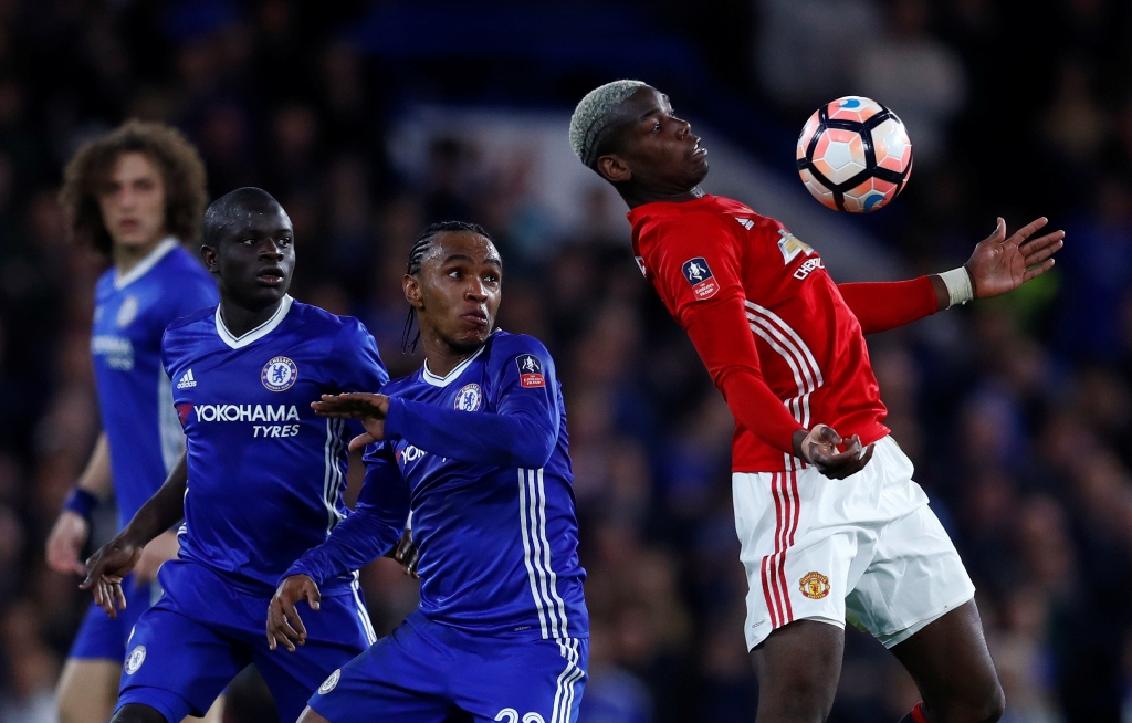 Manchester United's Paul Pogba in action with Chelsea's Willian and Victor Moses. Reuters / Eddie Keogh 