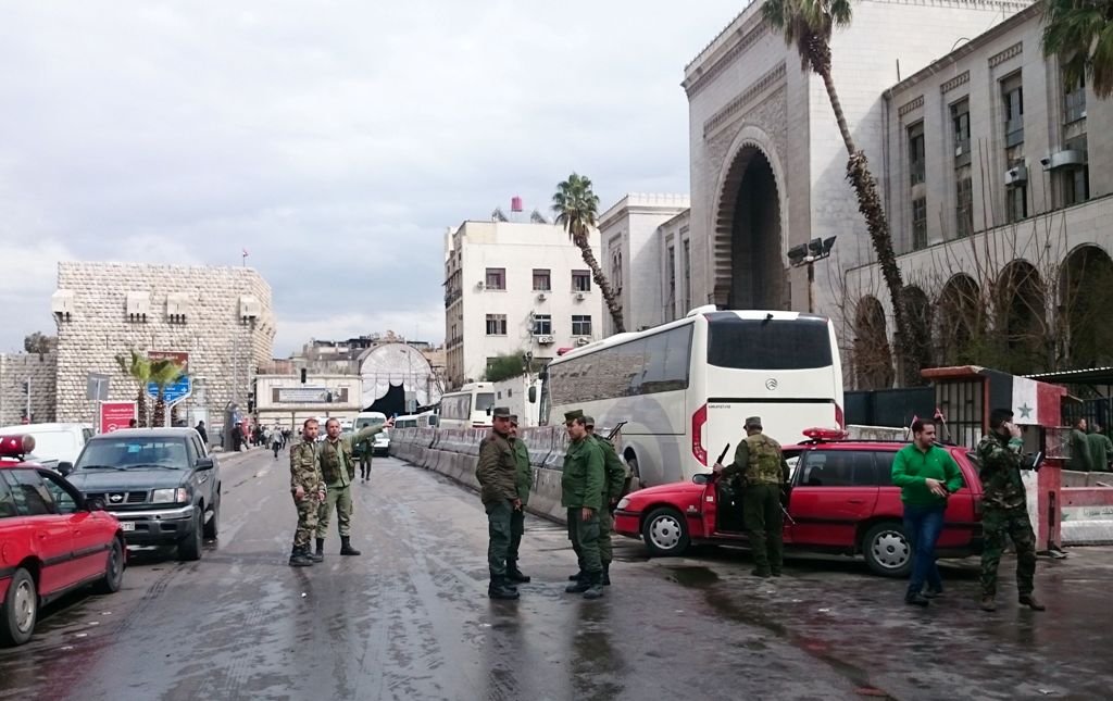 Syrian security forces cordon off the area following a reported suicide bombing at the old palace of justice building in Damascus on March 15, 2017.   AFP / STRINGER
