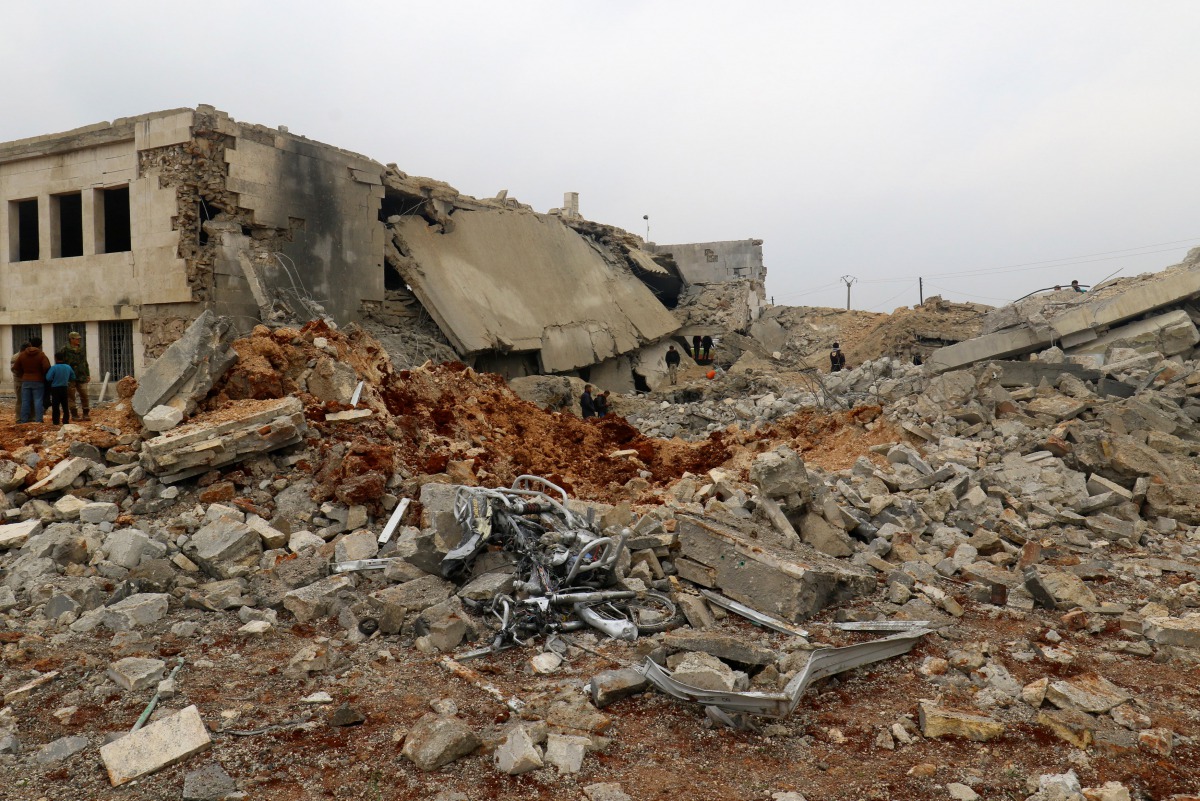 Civil defense members and people inspect a damaged mosque after an airstrike on the rebel-held village of al-Jina, Aleppo province in northwest Syria March 17, 2017. (REUTERS/Ammar Abdullah)