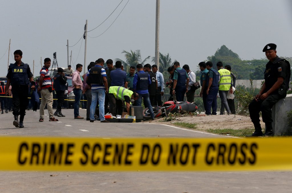 Crime Scene Unit works on the spot where police shot dead a suspected militant who tried to enter a security checkpost on a motorcycle armed with explosives in Khilgaon, outskirt of Dhaka, Bangladesh, March 18, 2017. REUTERS/Mohammad Ponir Hossain

