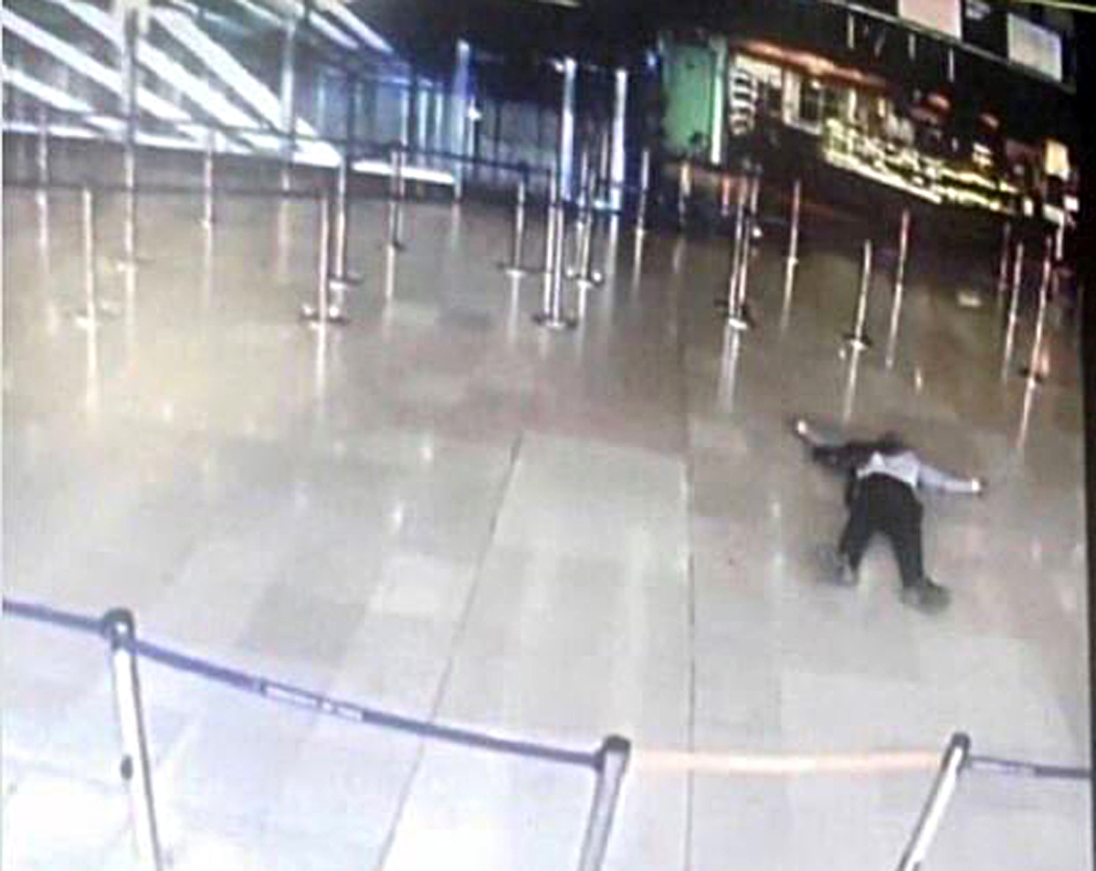 An airport CCTV screen image shows a man on the ground inside Orly Sud terminal following a shooting incident at Orly Airport near Paris, France March 18, 2017. REUTERS/CCTV via Twitter