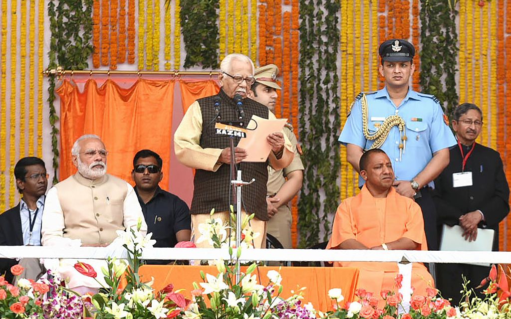 In this handout photograph released by The Indian Press Information Bureau (PIB) on March 19, 2017, India's Prime Minister Narendra Modi (2L) looks on as The Governor of the northern Indian state of Uttar Pradesh Ram Naik (C) presides over the swearing-in