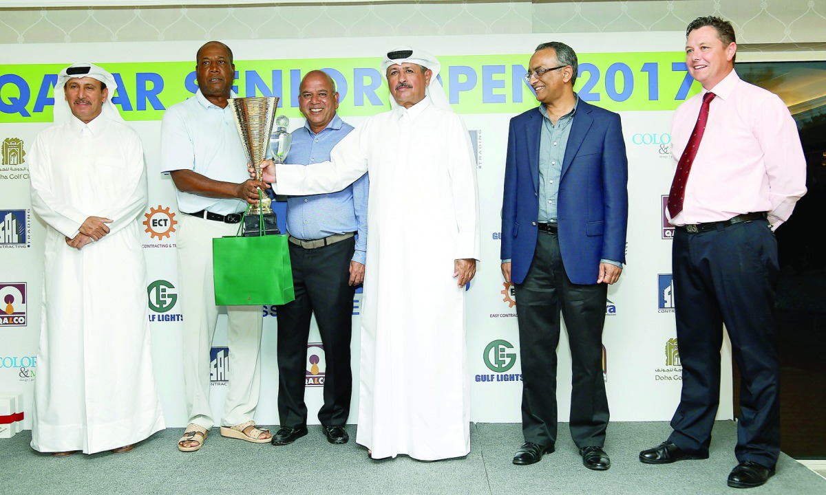 Fahad Nasser Al Naimi, the Secretary General of Qatar Golf Association (QGA) and Mohammed Faisal Al Naimi, the QGA Executive Director giving away the winner's trophy to Nasser Yacoob of Bahrain at the Qatar Senior Open Golf Championship 2017 at the Doha G