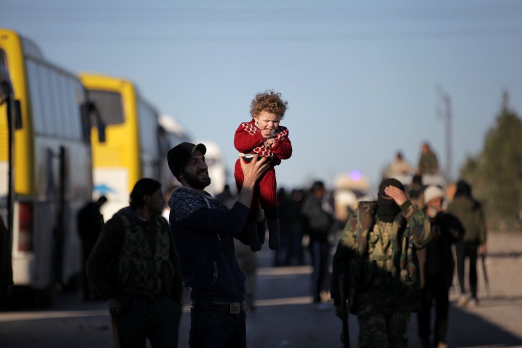 Rebel fighters and their families that evacuated the besieged Waer district in the central Syrian city of Homs, after an agreement reached between rebels and Syria's army, arrive on the southern outskirts of the Syrian city of al-Bab, Syria March 19, 2017