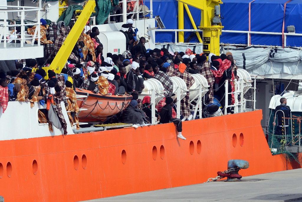 Would be immigrants wait to disembark in the port of Catania, on the island of Sicily on March 21, 2017 from the ship 
