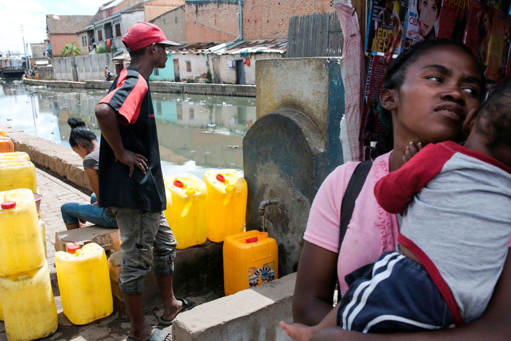 A man waits for his jerrycan to be filled at a public fountain during a period when the public water supply has been cut off, in the Isotry district of Antananarivo, Madagascar on March 17, 2017. 
/ AFP / RIJASOLO