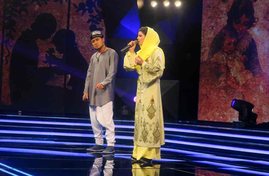 (FILES) This file photo taken on March 9, 2017 shows young Afghan singer Zulala Hashemi (R) alongside competitor Sayed Jamal Mubarez as they perform during the television music competition 'Afghan Star' in Kabul. AFP / Anne CHAON