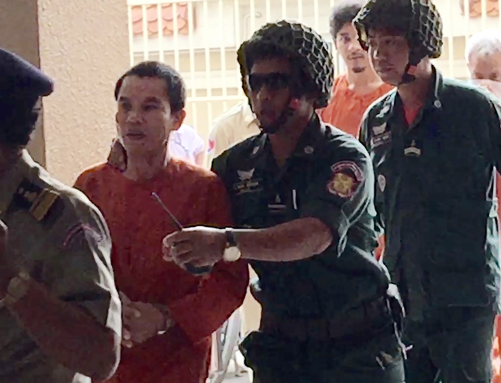 Cambodian Oeuth Ang (2nd L), an unemployed ex-soldier who calls himself 