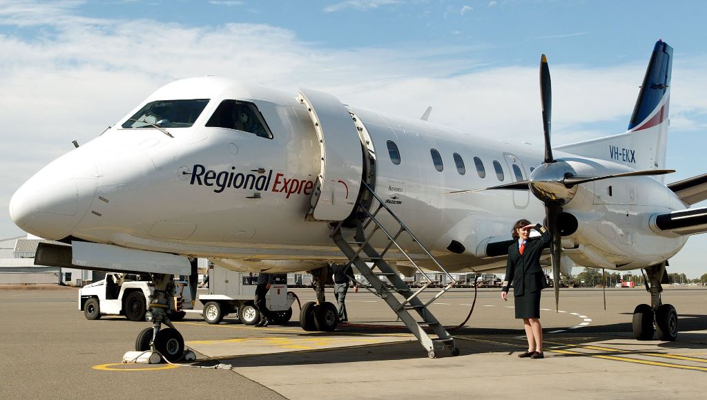 (FILES) A file photo taken on August 6, 2002, shows Captain Belinda Fleming standing in front of a Regional Express Airlines (REX) plane during the airline's launch at Sydney Airport. AFP / WILLIAM WEST
