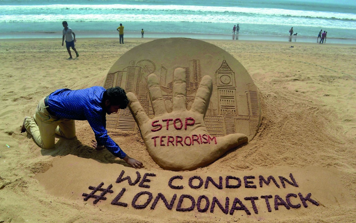  Indian sandartist Sudarsan Pattnaik gives the final touches to a sand sculpture on Puri Beach, some 65kms from Bhubaneswar on March 23, 2017, the day after an attack in London. Seven people have been arrested including some in London and Birmingham over 