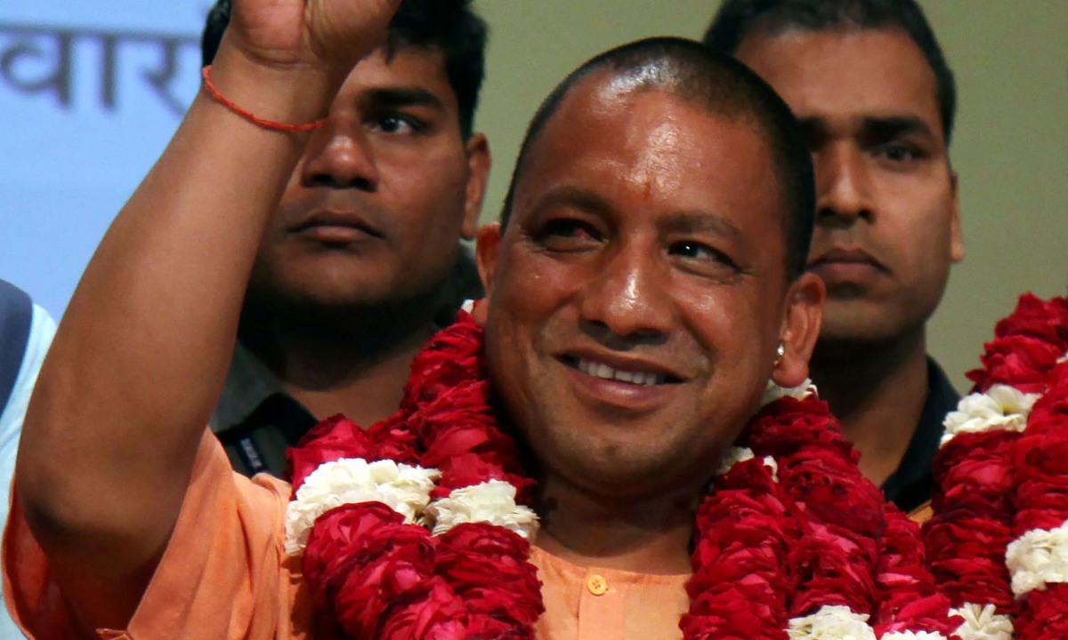 In this photograph taken on March 18, 2017, new Chief Minister of the northern Indian state of Uttar Pradesh Yogi Adityanath gestures to supporters as he is presented with a floral bouquet during a ceremony in Lucknow. AFP 
