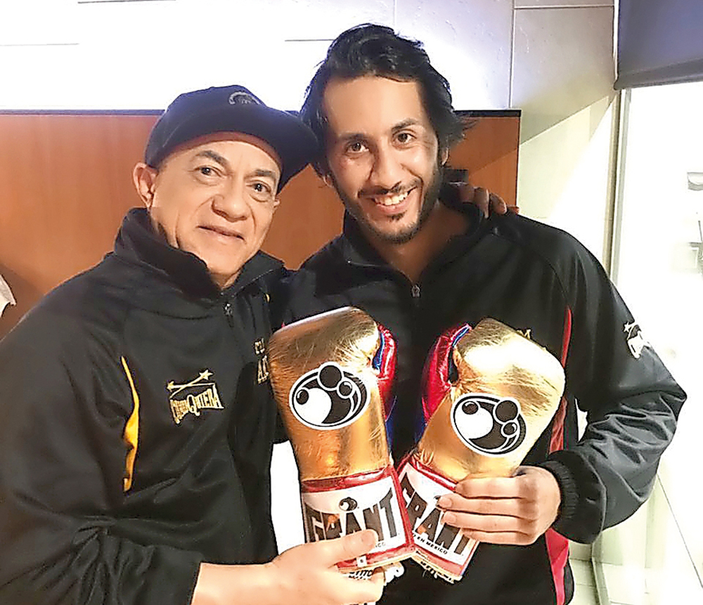 Qatar's first professional boxer Sheikh Fahad Khalid Al Thani (right) poses for a photograph with his trainer Ishmel Antonio Salas.