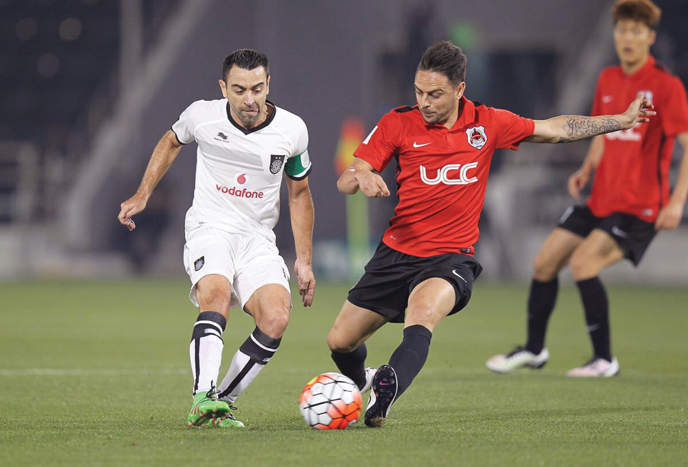 Al Sadd captain Xavi Hernandez (left) fights for the ball possession during a Qatar Stars League match, against Al Rayyan in this April 2016 file picture.
