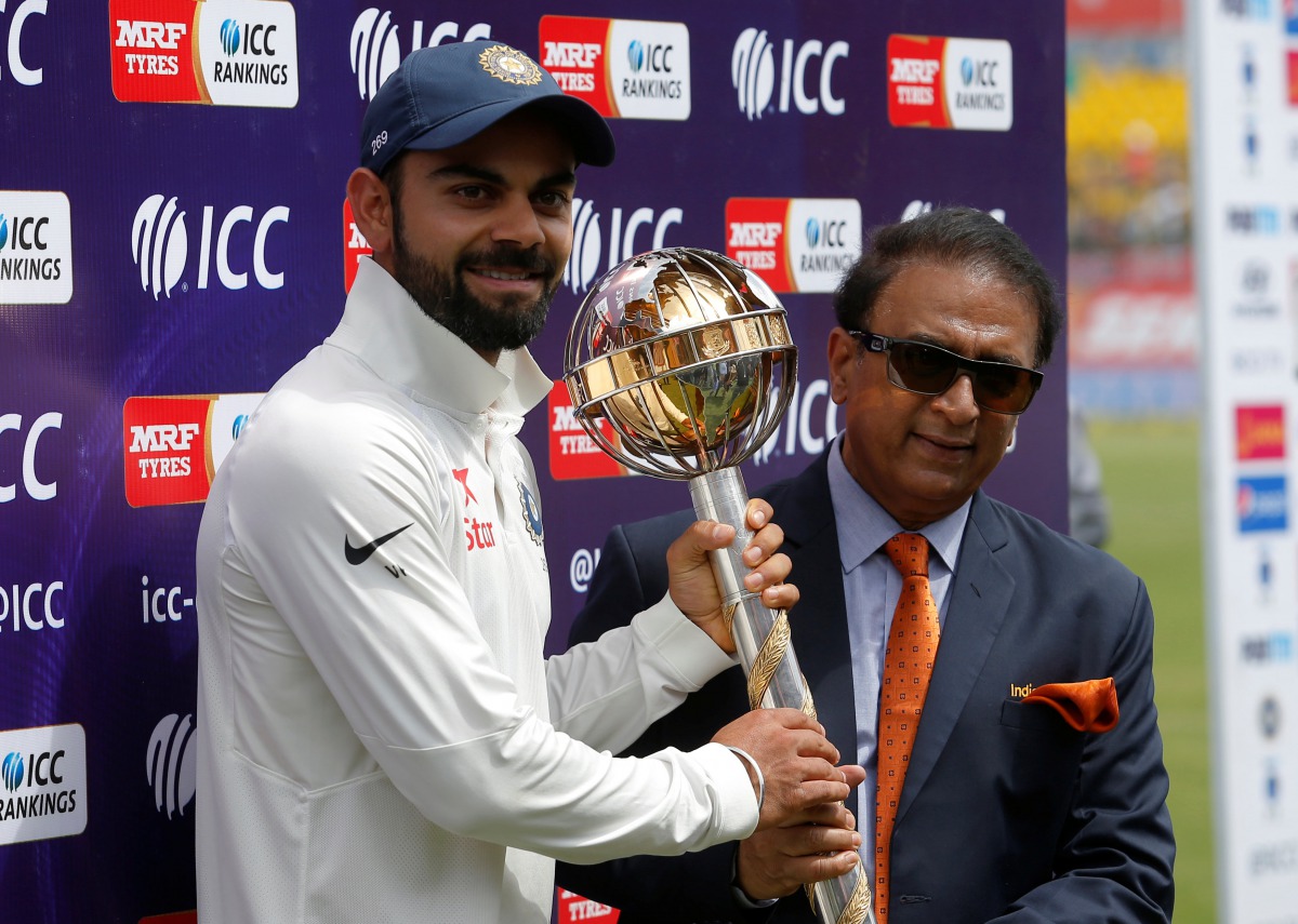 India's Virat Kohli receives the ICC Test Mace from former Indian cricket player Sunil Gavaskar (R) after India won the test series against Australia. (REUTERS/Adnan Abidi)