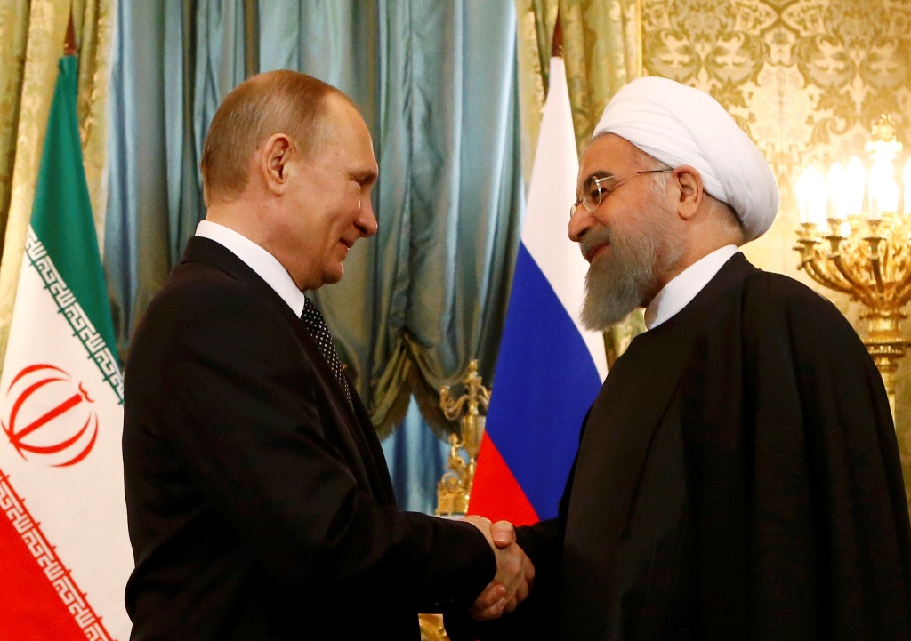 Russian President Vladimir Putin shakes hands with Iranian President Hassan Rouhani during their meeting at the Kremlin in Moscow, Russia March 28, 2017. REUTERS/Sergei Karpukhin
