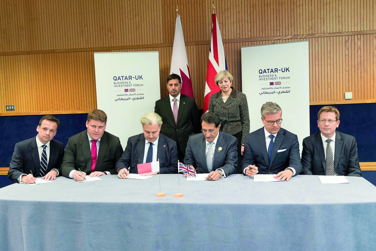 Prime Minister and Interior Minister H E Sheikh Abdullah bin Nasser bin Khalifa Al Thani (standing, left) and UK Prime Minister Theresa May(standing right) attending the signing of a shareholders agreement for Qatar Investment Authority's (QIA) acquisitio