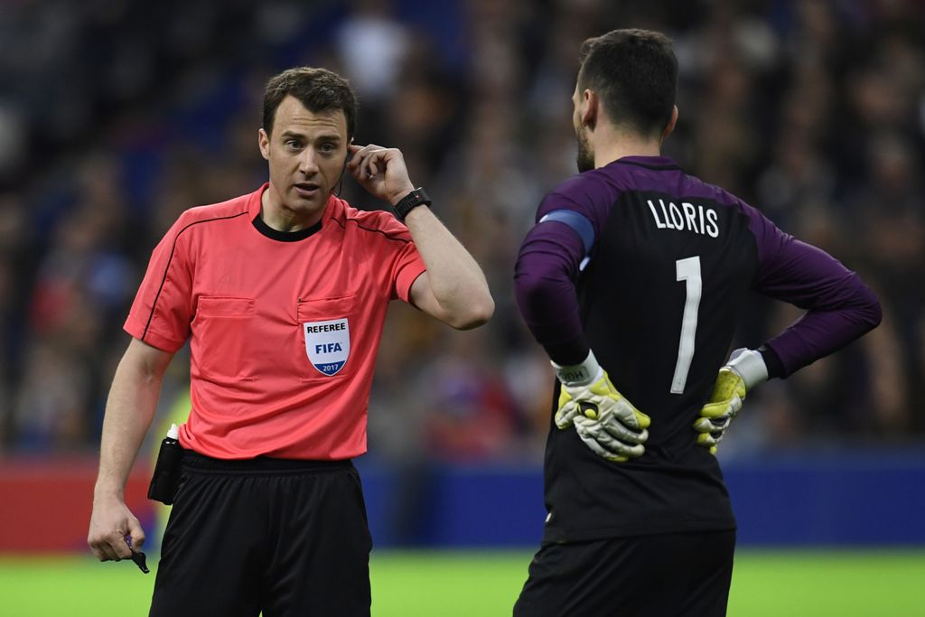 Referee Felix Swayer asks video assitance next to Hugo Lloris France's goalkeeper during the friendly football match France vs Spain on March 28, 2017 at the Stade de France stadium in Saint-Denis, north of Paris. / AFP / CHRISTOPHE SIMON
