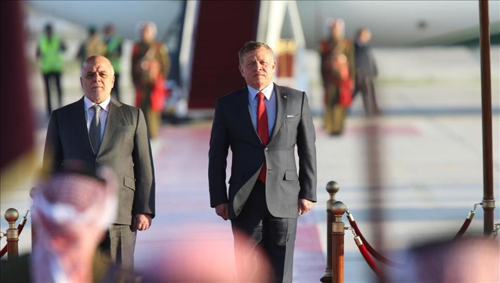 Iraqi Prime Minister Haider al-Abadi (L) is welcomed by Jordan's King Abdullah II (R) with an official ceremony at Queen Alia International Airport, as part of the 28th Arab League Summit in Amman, Jordan on March 28, 2017. (Salah Malkawi - Anadolu Agency
