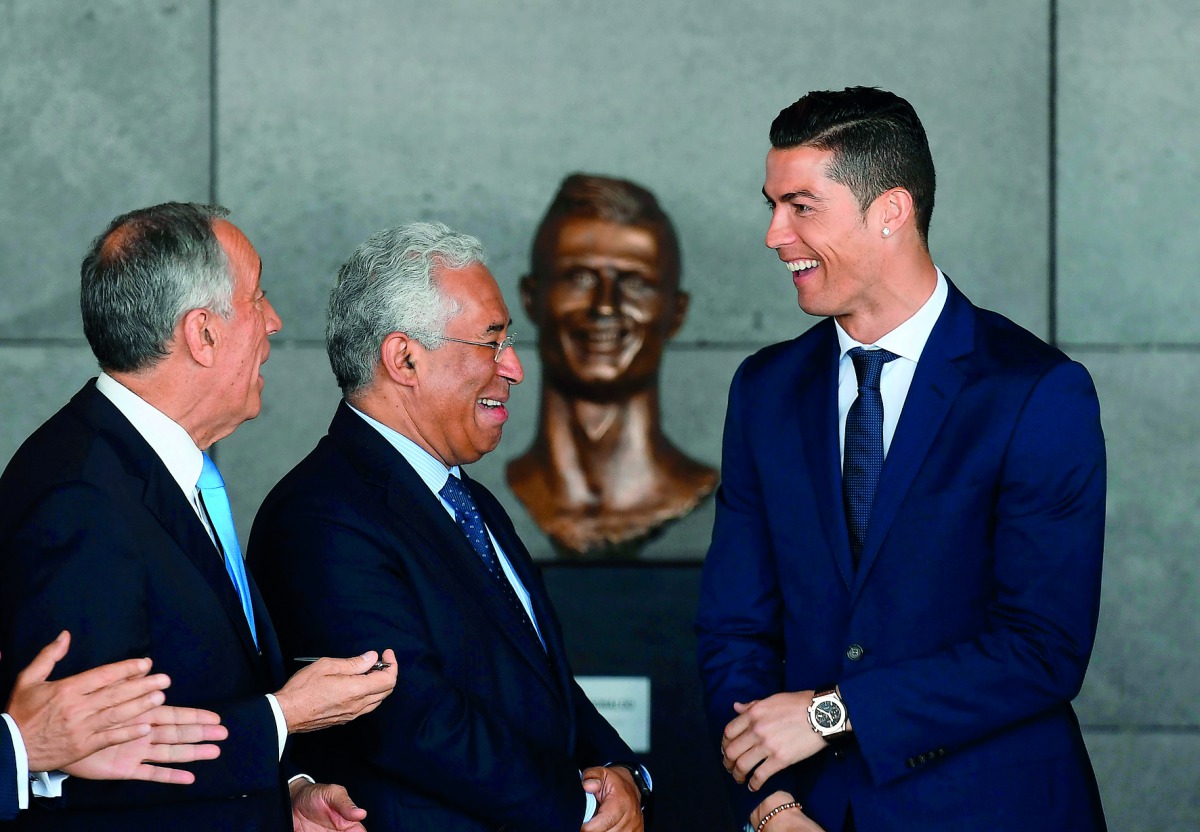 Portuguese footballer Cristiano Ronaldo (right), Portuguese Prime Minister Antonio Costa (centre) and Portuguese President Marcelo Rebelo de Sousa take part in a ceremony where Madeira's airport in Funchal was renamed after Cristiano Ronaldo, on Madeira i