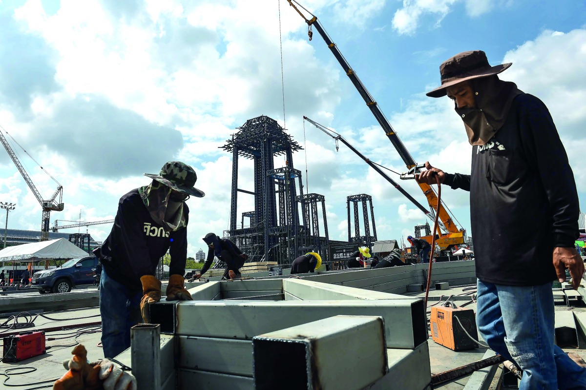 Workers assemble steel for one of the pavilions surrounding the late Thai king Bhumibol Adulyadej's funeral pyre in front of the Grand Palace in Bangkok, yesterday.