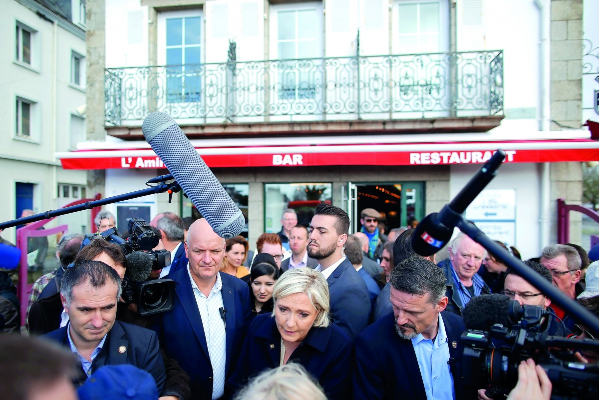 Marine Le Pen, French National Front leader and candidate for the presidential election, talking to residents as she visits a market in Concarneau, yesterday.