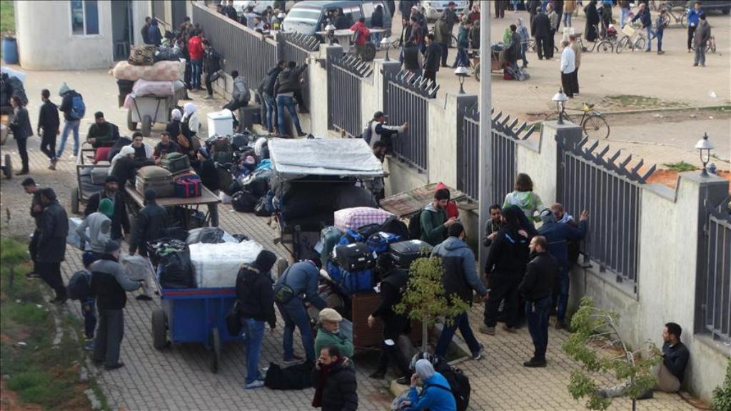 ALEPPO, SYRIA - MARCH 27: Syrian civilians and opponents wait for buses to be evacuated from Al-Waer district of Homs, in Aleppo, Syria on March 27, 2017. Third group of around 800 people to be evacuated from Al-Waer district, where ceasefire is violated 