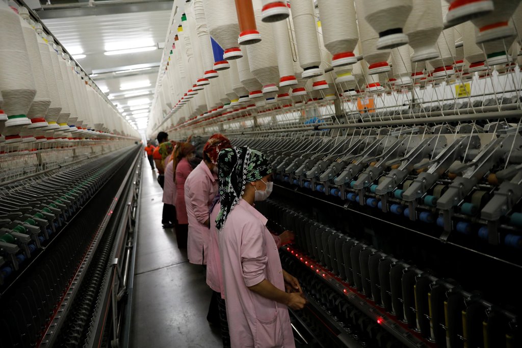 Workers are seen in front of a product line in a textile factory in Diyarbakir March 21, 2017. Picture taken March 21, 2017. REUTERS/Umit Bektas
